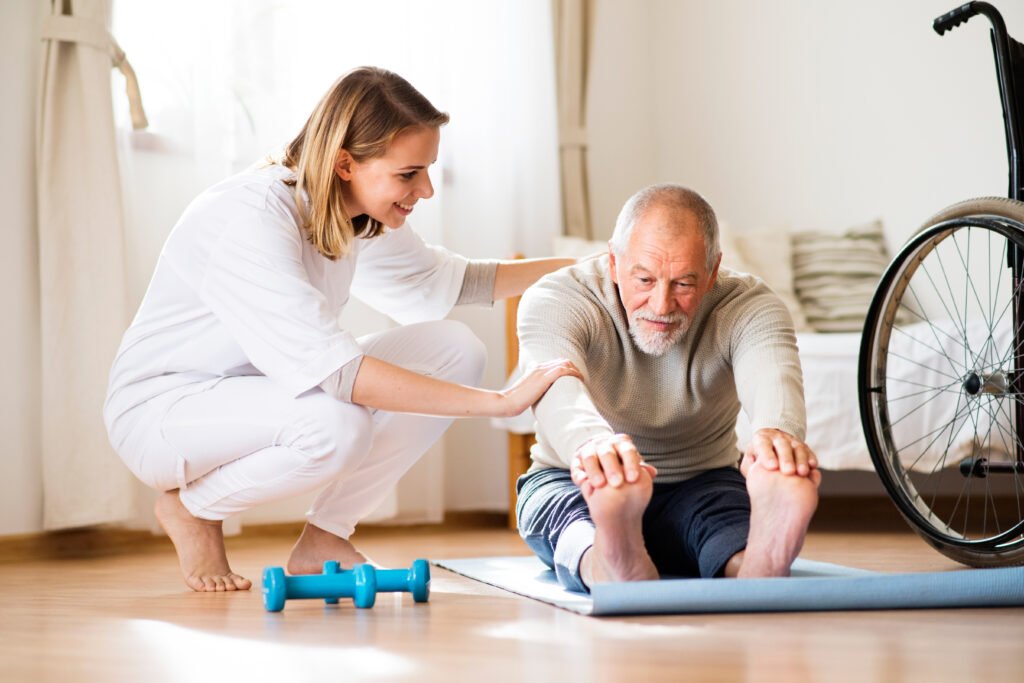 Physiotherapist assisting patient with rehabilitation exercises at home in British Columbia