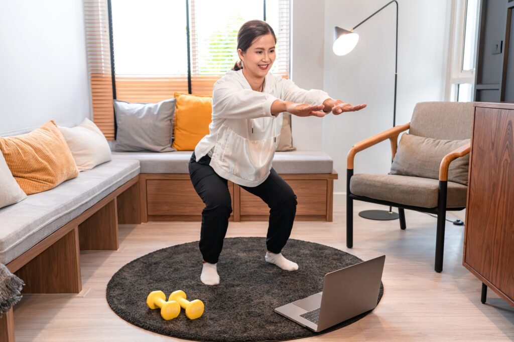 Woman performing physiotherapy exercises at home during an online virtual session