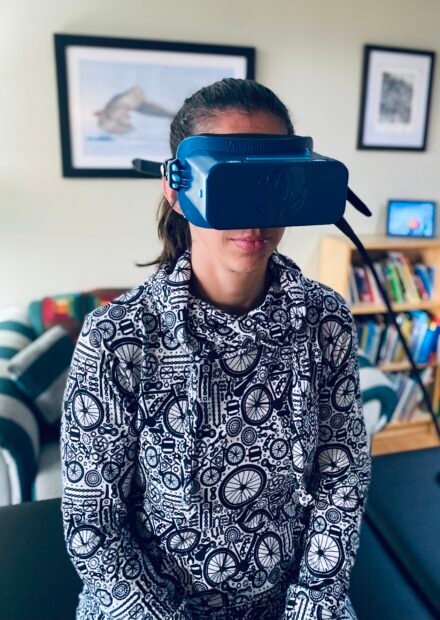 Patient wearing virtual reality headset during vestibular rehabilitation therapy